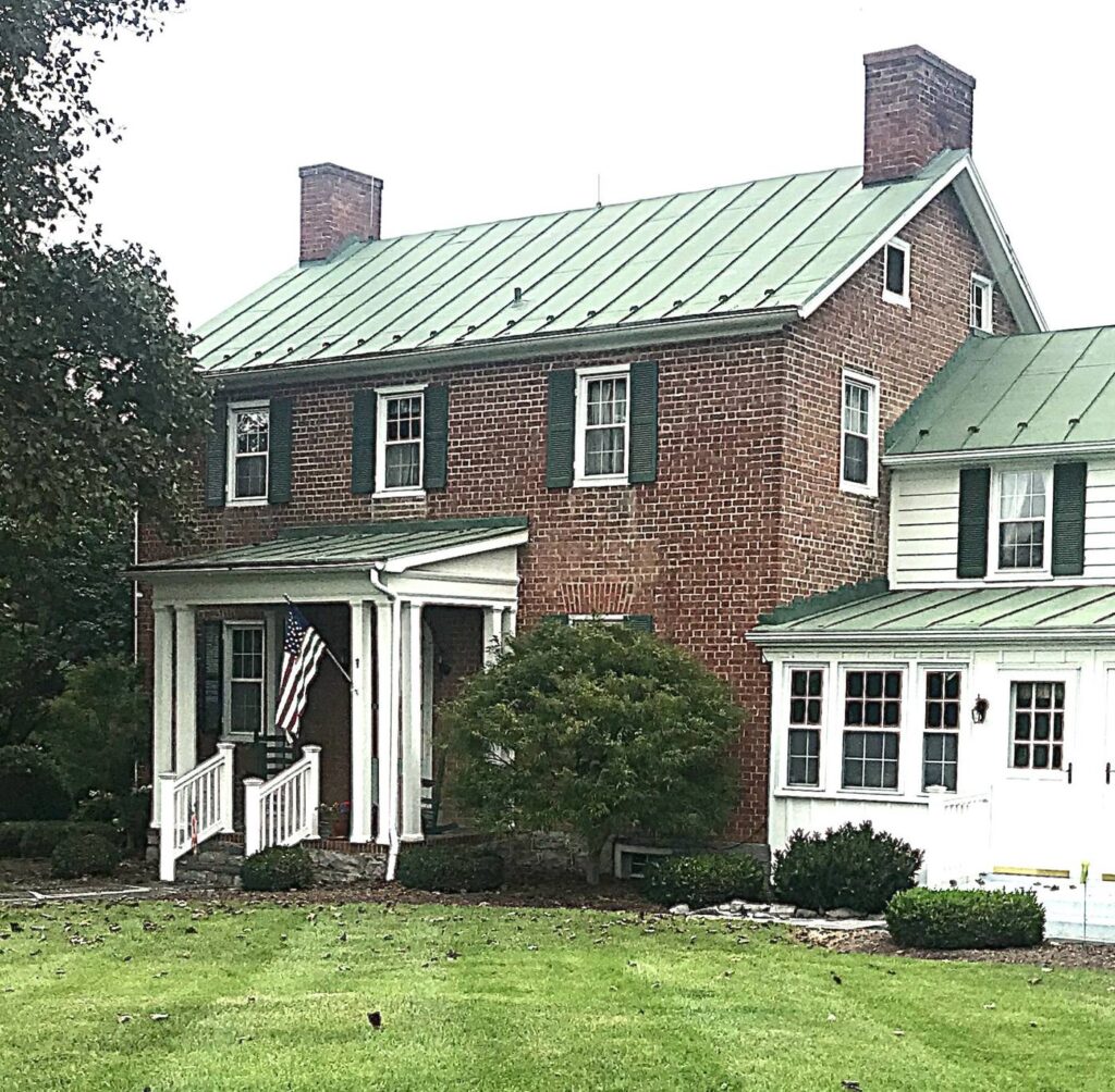 Brick Henry Wenger home at Farmingreen with green metal roofs